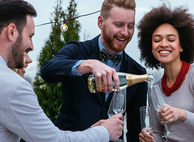 Three people pouring champagne