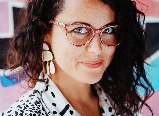 Smiling woman with pink glitter eyeglasses