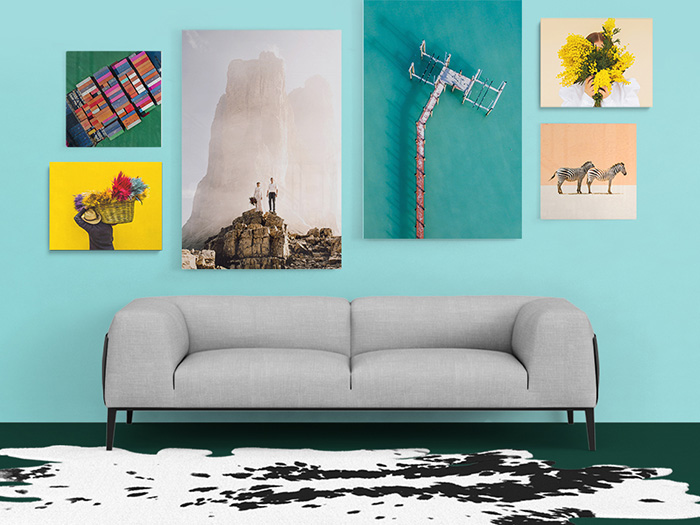 Collection of wall prints on a teal wall