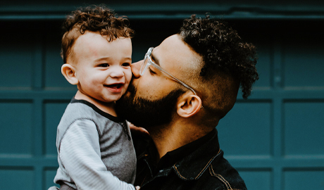 A man kissing a baby
