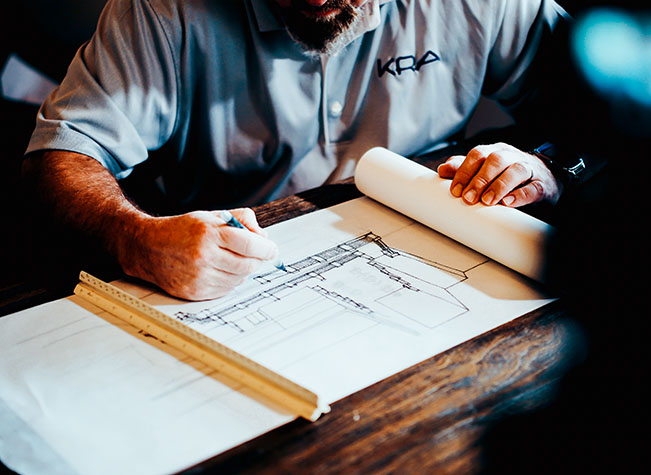 A man sketching architecture plans