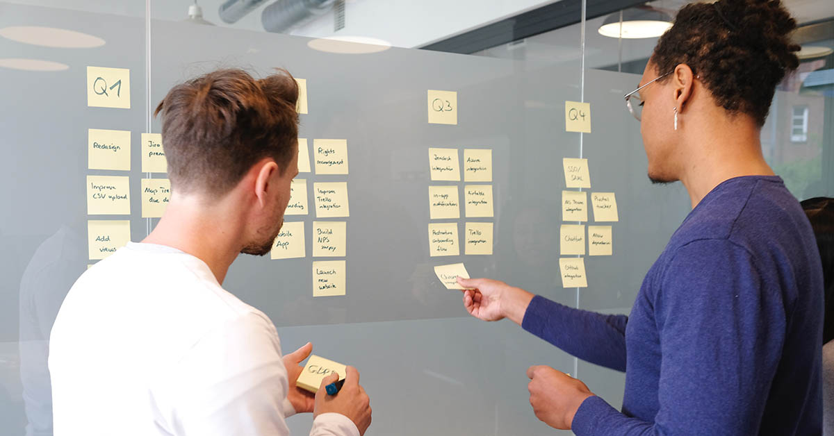 Two people working together with sticky notes