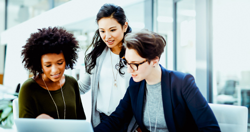 Three diverse women looking at a computer screen