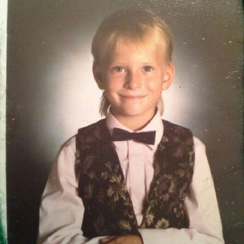 Amie Crawford as a child with vest and bowtie.