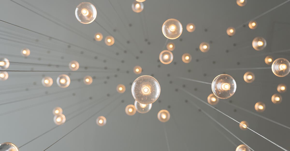 Light bulbs floating from sky