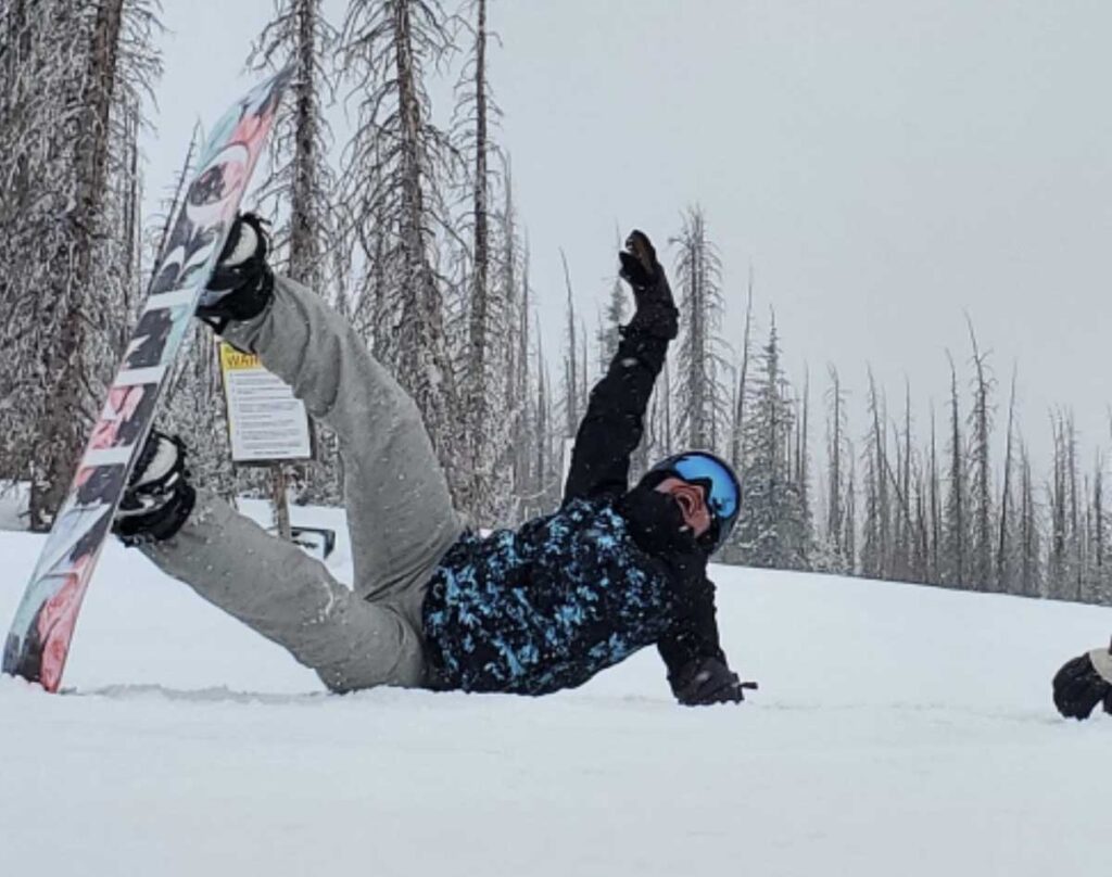 Kelsey Brown falling while snowboarding