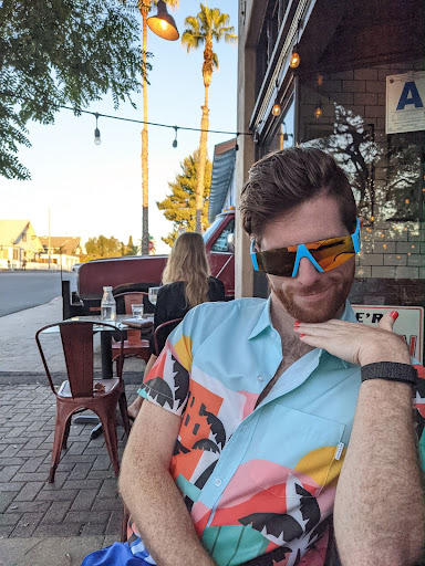 Image of Greg Erickson with sunglasses on at a restaurant posing for camera