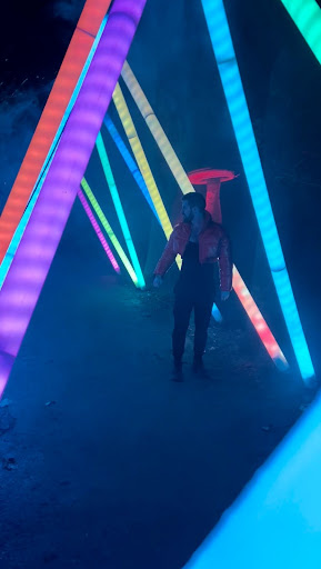 Image of Greg Erickson walking through lights