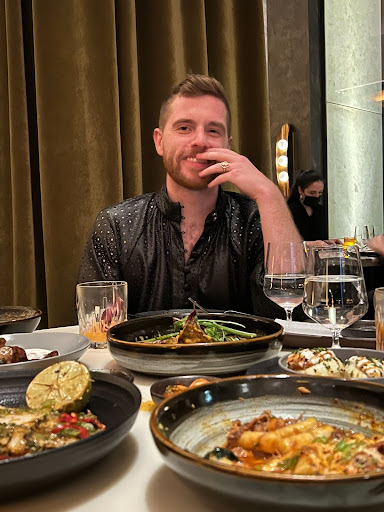 Image of Greg Erickson smiling at camera at a restaurant