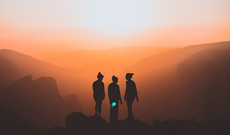 three women standing on mountain