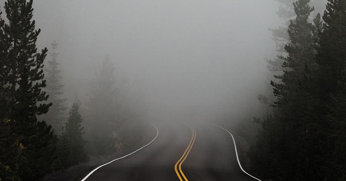 Road leading into misty moutains