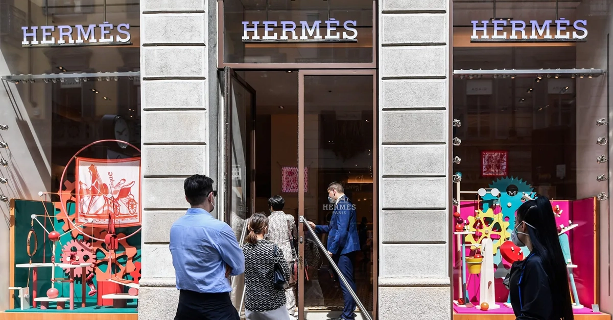 People standing outside a Hermes store